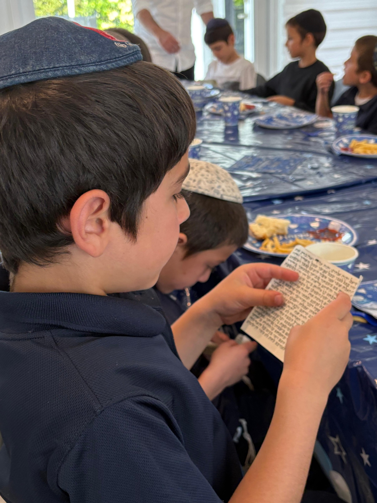 Boy studying parchment up close